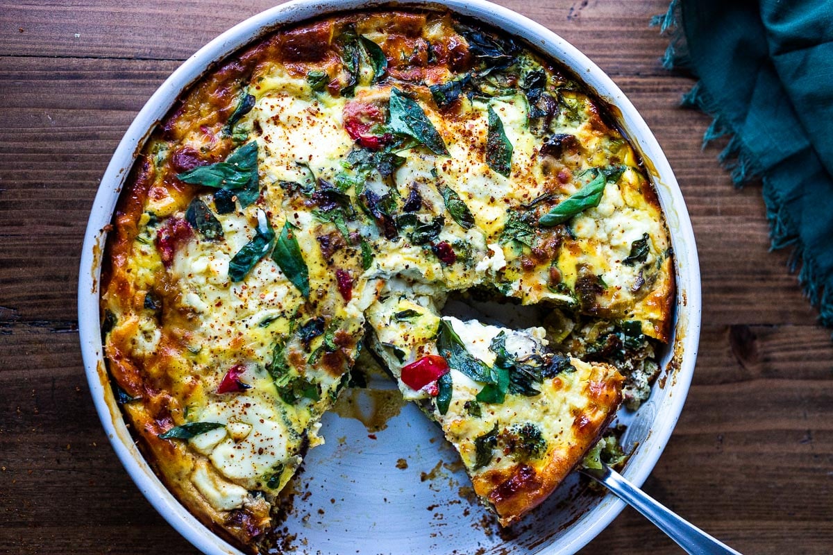 This delicious Baked Frittata is easy to make, full of healthy vegetables, and very versatile. It can be made ahead - perfect for a holiday breakfast or brunch, or serve it up for lunch or dinner -an easy, clean-out-the fridge kind of meal. This crustless quiche is Keto, Gluten-free and low-carb. #frittata #healthybreakfast