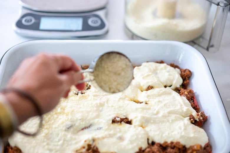 Sprinkling the ricotta with pecorino cheese.