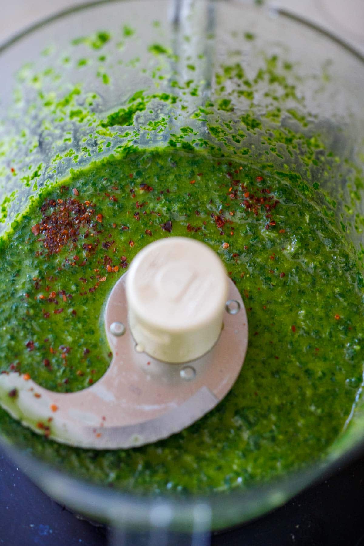 blending basil oil in a food processor.